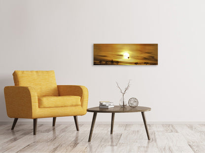 Leinwandbild Panorama Sonnenuntergang mit Heissluft Ballon